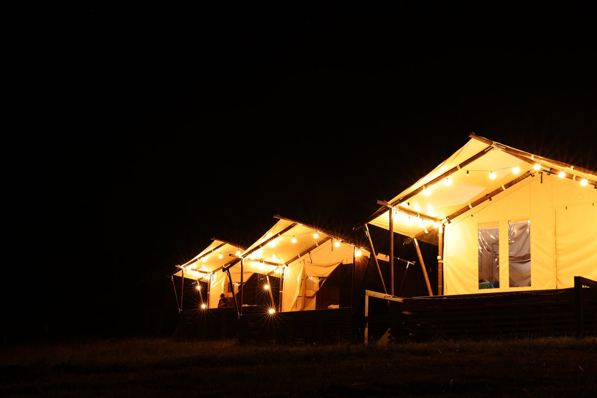 Tents in mountains at night glamping site under stars